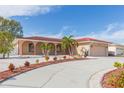 Circular driveway and lush landscaping enhance this home's curb appeal at 6512 Manila Palm Way, Apollo Beach, FL 33572