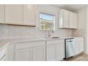 White shaker cabinets, quartz countertops, stainless steel dishwasher at 10336 Cross River Trl, Parrish, FL 34219