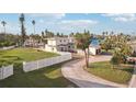 Aerial view showing home's exterior, landscaping, and circular driveway at 15825 Redington Dr, Redington Beach, FL 33708