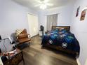 Cozy bedroom with a double bed, dark wood floors, and a ceiling fan at 1716 Westerly Dr, Brandon, FL 33511