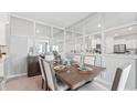 Bright dining room with a wooden table and mirrored wall at 2375 Warren Acres Blvd, Wesley Chapel, FL 33543