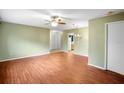 Open living room showcases wood floors and neutral paint, creating a bright and airy space at 2549 Oakleaf Ln # 36C, Clearwater, FL 33763