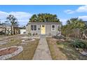 Gray house with yellow door, landscaped yard, and walkway at 4809 11Th S Ave, St Petersburg, FL 33711