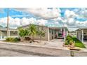 Tan mobile home with carport and nicely landscaped front yard at 8624 Fantasia Park Way, Riverview, FL 33578