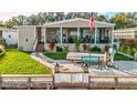 Charming manufactured home with a spacious covered porch and manicured lawn at 8624 Fantasia Park Way, Riverview, FL 33578