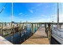 Wooden walkway along the waterfront with docked sailboats at 907 Bahia Del Sol Dr, Ruskin, FL 33570