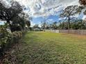 Vacant lot, grassy area, and neighboring houses at 10002 Memorial Hwy, Tampa, FL 33615