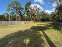 Large vacant lot with mature trees and grassy area at 10002 Memorial Hwy, Tampa, FL 33615