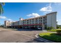 Two-story condo building with covered parking and landscaping at 19029 Us Highway 19 N # 8-25, Clearwater, FL 33764