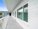 White hallway with white railings and windows along the condo building at 2002 Australia E Way # 66, Clearwater, FL 33763