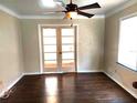 Bright living room boasts hardwood floors, French doors, and a modern ceiling fan at 3246 Prescott N St, St Petersburg, FL 33713
