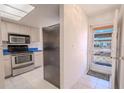 Kitchen entry with stainless steel appliances and view of the outdoors at 3743 Teeside Dr, New Port Richey, FL 34655
