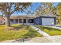 Ranch style home with a two-car garage and mature landscaping at 1040 31St E St, Palmetto, FL 34221