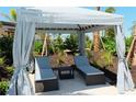 Relaxing cabana with two lounge chairs and a small table at 18307 Wheathouse Pl, Lakewood Ranch, FL 34211