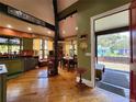 Rustic kitchen with wood floors, green cabinets, and a dining area at 2515 York S St, Gulfport, FL 33707