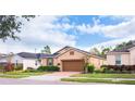 Two-story house with brown garage door and landscaping at 3148 Macintosh Rd, Land O Lakes, FL 34639