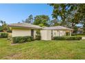 Single story home with landscaped lawn and gated entry at 970 Rolling Hills Dr, Palm Harbor, FL 34683