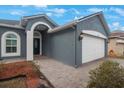 Gray house with arched entryway and white accents at 10212 Grant Creek Dr, Tampa, FL 33647