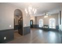 Living room with hardwood floors, chandelier, and archways at 10212 Grant Creek Dr, Tampa, FL 33647