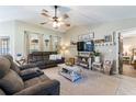 Spacious living room featuring a cozy seating area and large TV at 11078 Hemlock Warbler Rd, Weeki Wachee, FL 34614