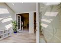 Bright foyer with wood-look tile floors, a glass front door and views of the main living area at 1612 Sunset Dr, Tarpon Springs, FL 34689