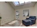 Sunroom with skylights, leather chair, and French doors leading outside at 1612 Sunset Dr, Tarpon Springs, FL 34689