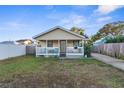 House exterior showcasing a porch and well-maintained lawn at 3436 51St N Ave, St Petersburg, FL 33714