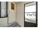 Front entrance with storm door and steps leading to the home at 35216 Dodie Dr, Zephyrhills, FL 33541