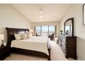 Spacious bedroom with dark furniture, a comfy bed, a balcony, and a beautiful view at 7540 Sunshine Skyway S Ln # 220, St Petersburg, FL 33711