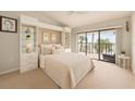 Bright bedroom with a balcony overlooking the beach, built-in shelving, and a comfortable bed at 7540 Sunshine Skyway S Ln # 220, St Petersburg, FL 33711