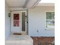 Front entrance with a decorative door and stone steps at 8134 Bayshore Dr, Seminole, FL 33776