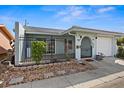 Front view of a light blue house with a white garage door and a gated entrance at 10449 Larchmont N Pl, Pinellas Park, FL 33782