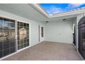 Covered tiled patio with sliding glass doors leading to the interior at 10449 Larchmont N Pl, Pinellas Park, FL 33782