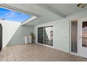 Tiled patio with sliding glass doors and exterior access at 10449 Larchmont N Pl, Pinellas Park, FL 33782