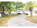 House exterior showcasing a two-tone color scheme and a palm tree at 11300 Yellowwood Ln, Port Richey, FL 34668