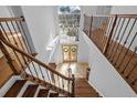 Bright foyer with a large window, wooden staircase, and decorative front doors with wreaths at 22847 Sonoma Ln, Lutz, FL 33549