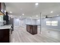 Open kitchen with island and stainless steel appliances at 4110 Wedgemere Dr, Tampa, FL 33610
