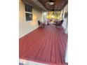 Spacious red porch with seating area, ceiling fan and white railings at 4616 River Hills Dr, Tampa, FL 33617