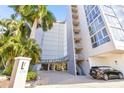 Exterior view of The Beacon building entrance, with palm trees and driveway at 470 3Rd S St # 405, St Petersburg, FL 33701