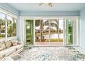 Bright sunroom with water views and comfortable seating, perfect for relaxation at 4817 Sandy Glen Way, Wimauma, FL 33598