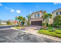 Two-story house with brown garage door and landscaping, viewed from the street at 4943 Grand Oak Cir, Madeira Beach, FL 33708