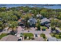 An elevated view of a neighborhood featuring lush landscaping, mature trees, and a waterfront backdrop at 13182 72Nd Ter, Seminole, FL 33776