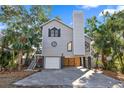 Two-story house with gray siding, a large window, and a two-car garage at 13182 72Nd Ter, Seminole, FL 33776