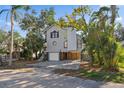 Modern two-story house with gray siding, spacious driveway, and mature landscaping at 13182 72Nd Ter, Seminole, FL 33776