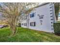 Building exterior showcasing name and landscaping at 200 Glennes Ln # 206, Dunedin, FL 34698