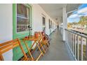 Outdoor hallway with seating area and green accents at 200 Glennes Ln # 206, Dunedin, FL 34698