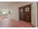Condo entry with double doors and decorative wreath at 2900 Gulf Blvd # 212, Belleair Beach, FL 33786
