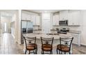 Modern kitchen with white cabinets, granite countertops, and stainless steel appliances at 2919 Grand Kemerton Pl, Tampa, FL 33618