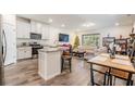 Open floor plan with kitchen island, living room, and dining area at 2919 Grand Kemerton Pl, Tampa, FL 33618