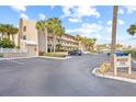 Condo building with parking and signage, sunny day at 3400 Gulf Blvd # 105, Belleair Beach, FL 33786